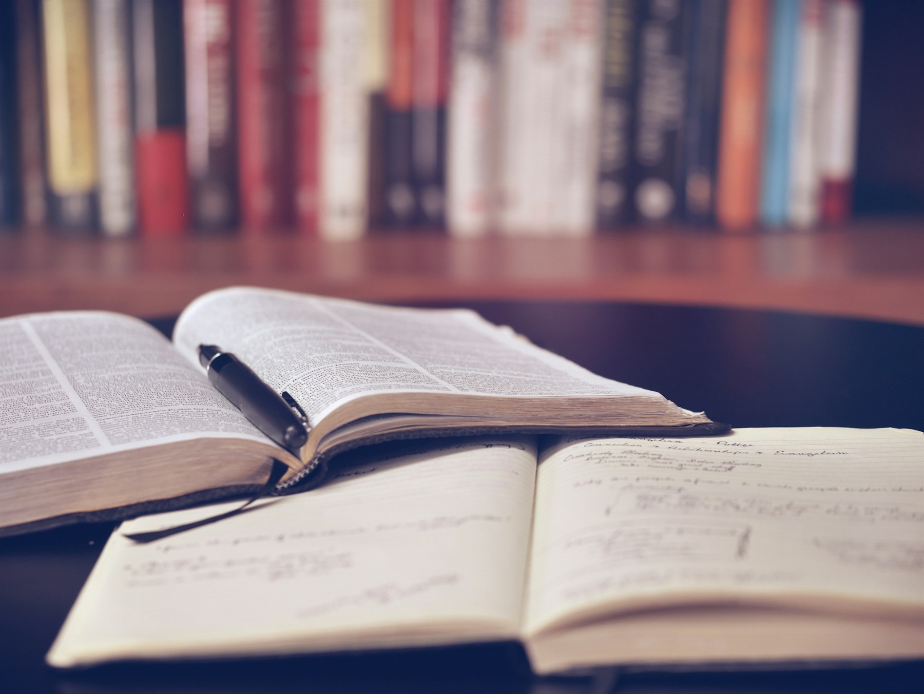 Open books and notes on a reading table