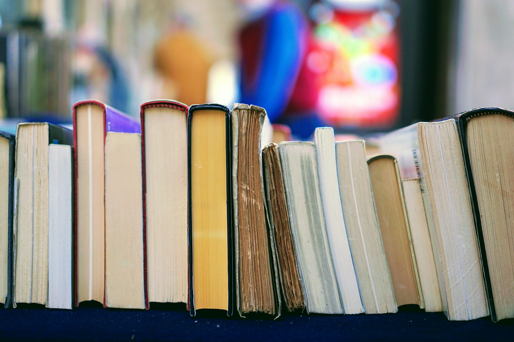 An open book surrounded by shelves in a bookshop